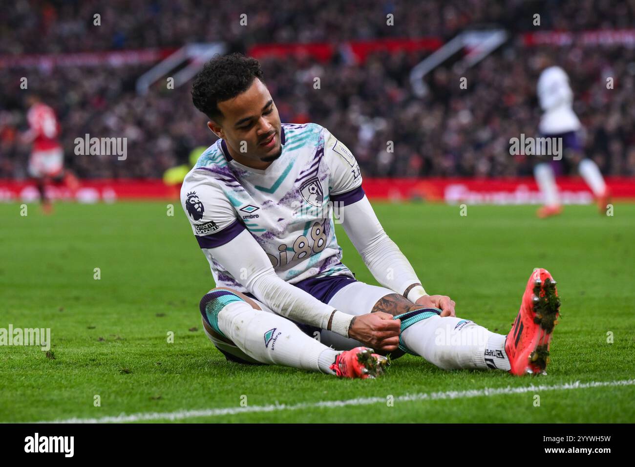 Justin Kluivert Of Bournemouth Sits On The Floor Adjusting His Sock