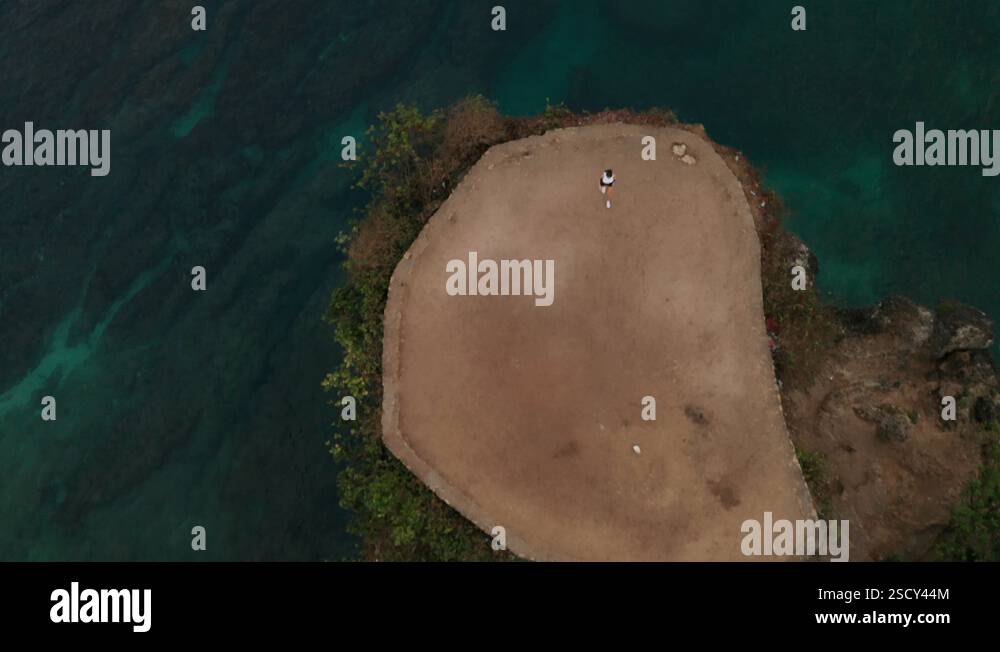 Aerial View Of Woman Exercising On Sea Shore Cliff At Sunrise Stock