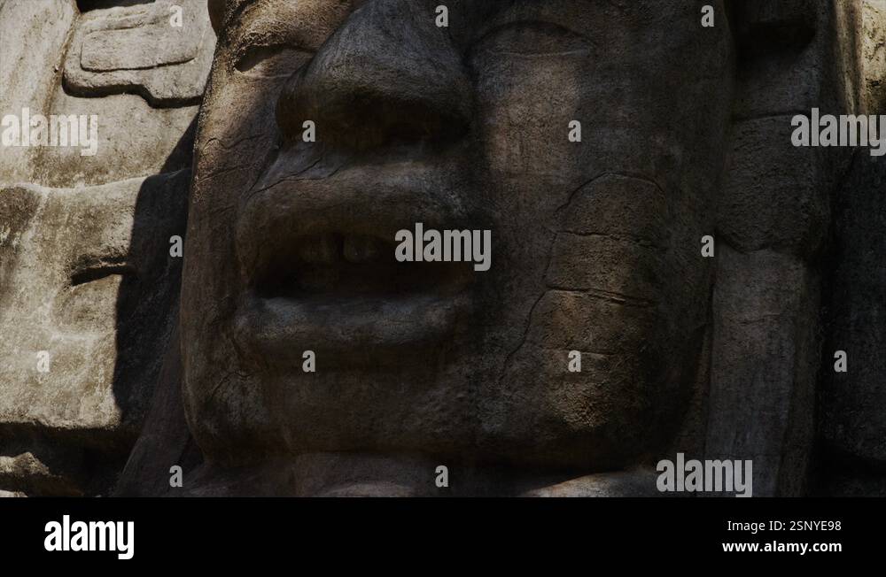 Close Up Panning Shot Of Stone Face At Mask Temple Mask Temple