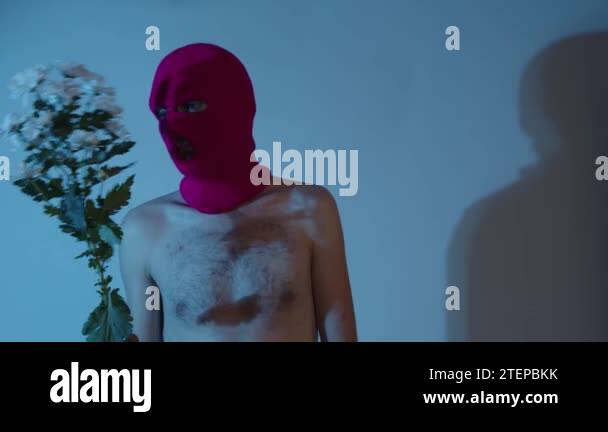 Anonymous Shirtless Man In Balaclava With Flowers Unrecognizable