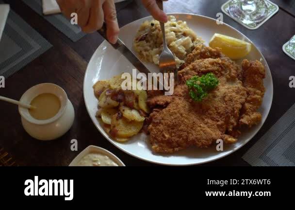 Eating Pork Schnitzel Austria Cuisine Battered Meat With Sauerkraut And