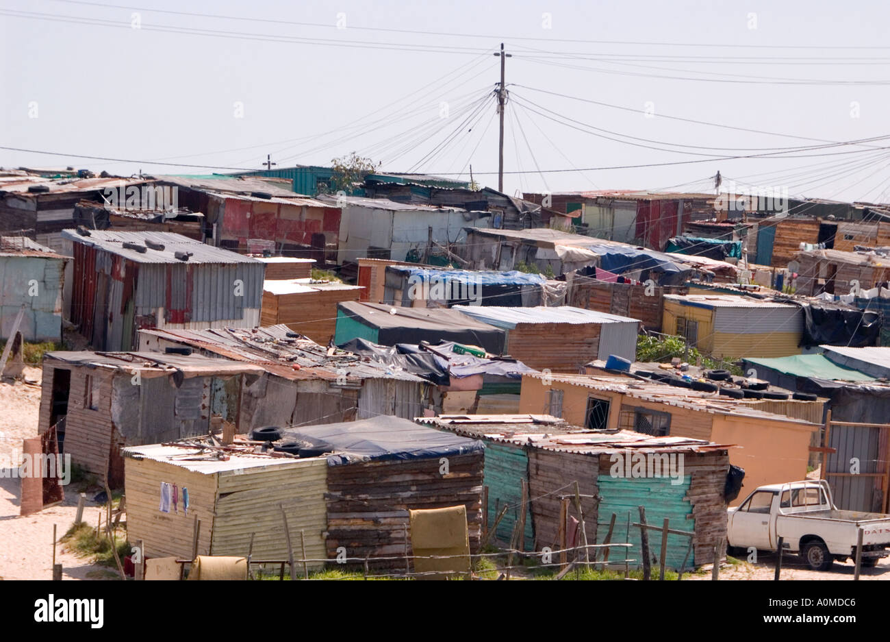 A view of shanties with power lines overhead in a township Cape Town