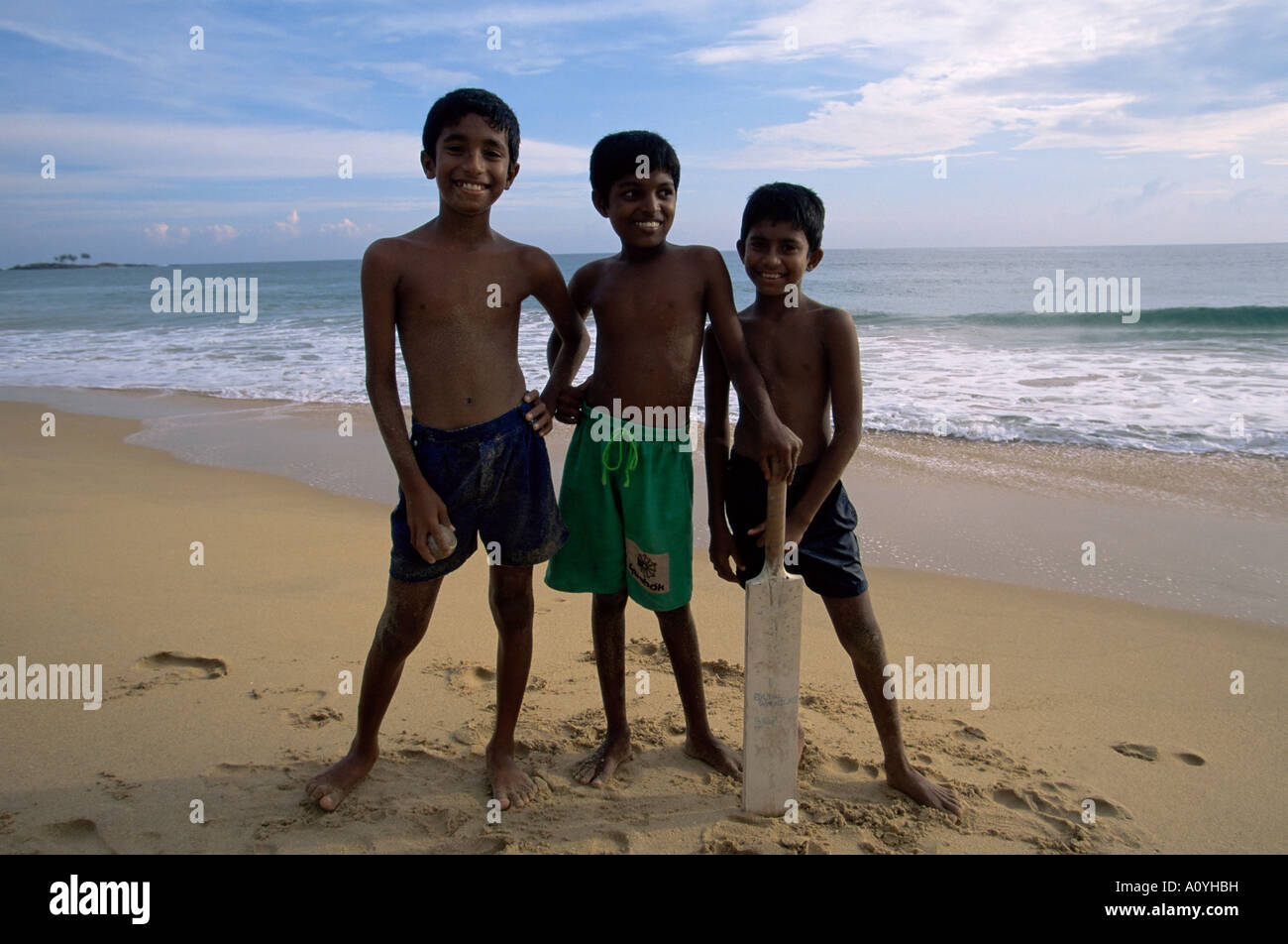 Boys playing cricket Hikkaduwa beach Sri Lanka Asia Stock Photo