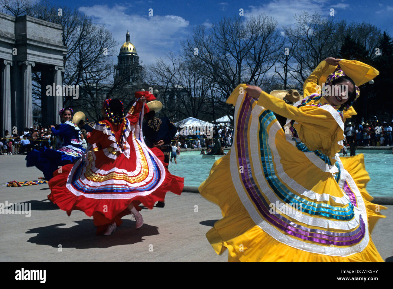Hispanic female dancers in colorful costumes celebrate Cinco de Mayo