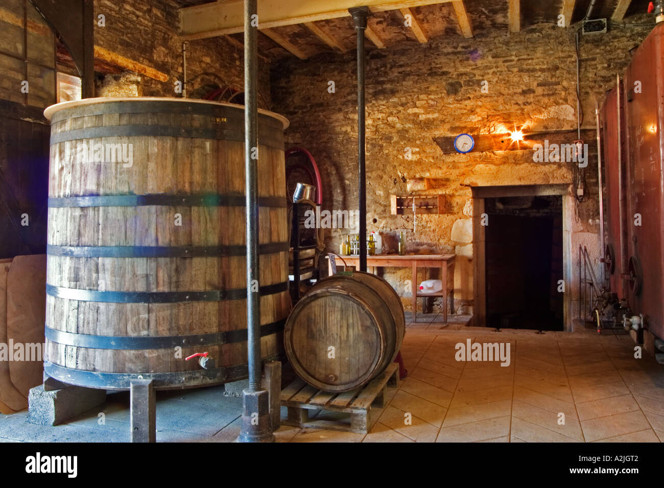 In the winery an old oak vat an old oak barrel and stone walls. Very