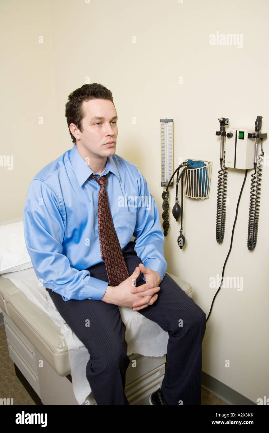 Male patient waiting for doctor to start an physical exam 