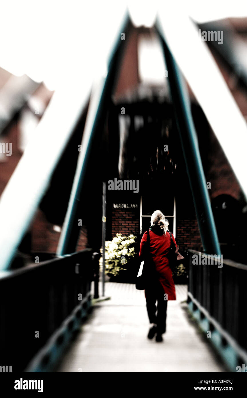 Woman Walking Over Bridge In Red Coat Stock Photo Royalty Free