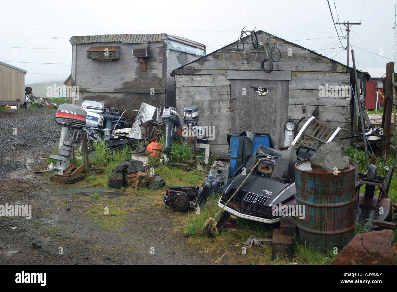 Spare parts and junk stored outside of a cabin in Goodnews Bay Stock Photo, Royalty Free Image