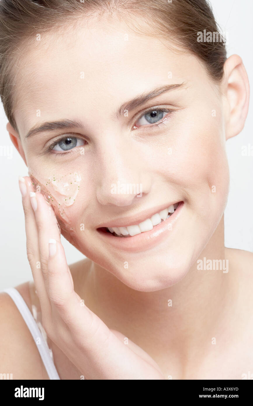 Close up of a young woman applying gel on face Stock Photo - close-up-of-a-young-woman-applying-gel-on-face-A3X6YD
