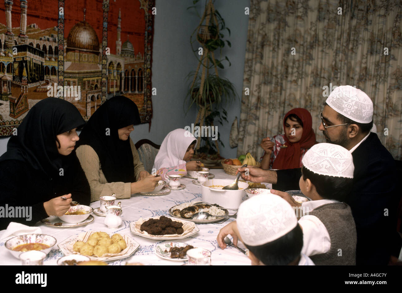Muslim family celebrating end of Ramadan with meal called Iftar which