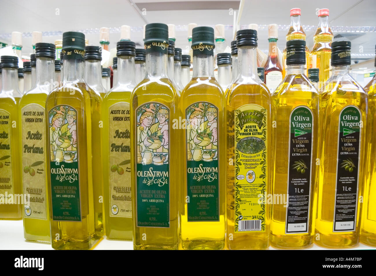 Bottles of Spanish olive oil lined up on supermarket shelf in Spain