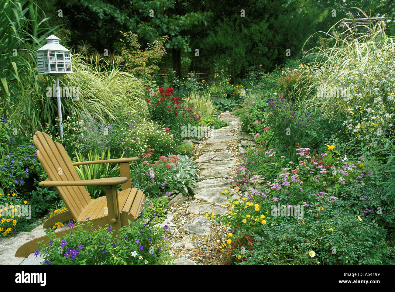 rock garden path curves through flower garden with chair and birdhouse united states of america usa - Flower Garden Path rock garden path curves through flower garden with chair and birdhouse united states of america usa - Flower Garden Path