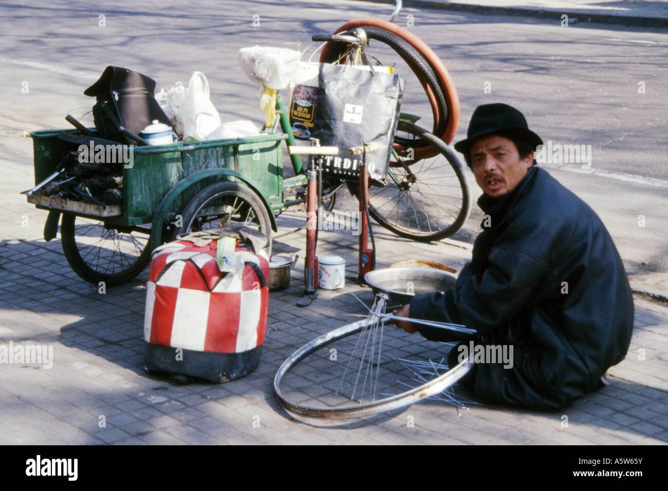 Local-bicycle-repair-man-working-on-a-bi