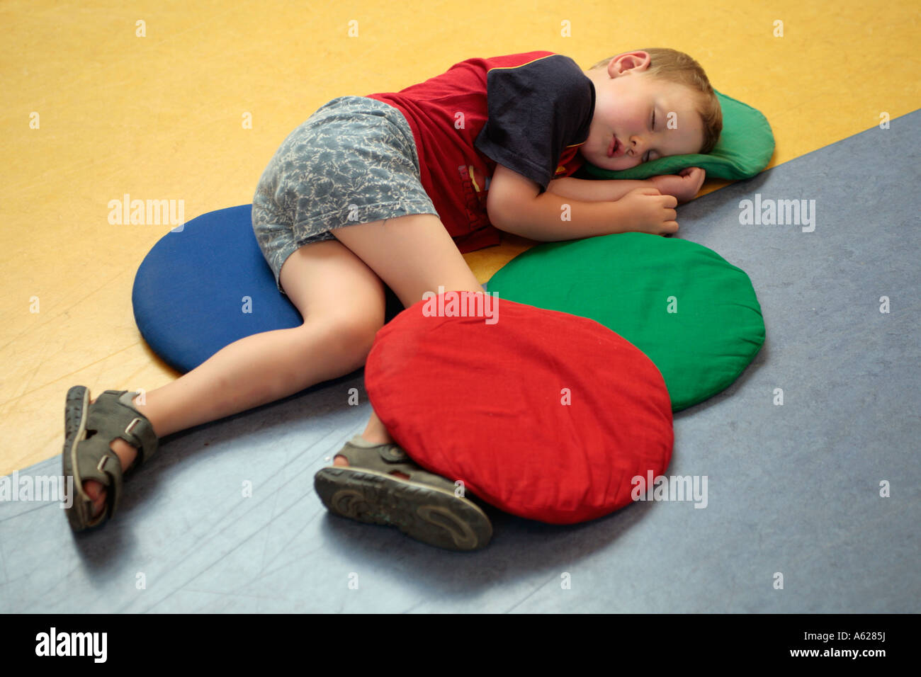 portrait of a little boy sleeping on the floor Stock Photo, Royalty