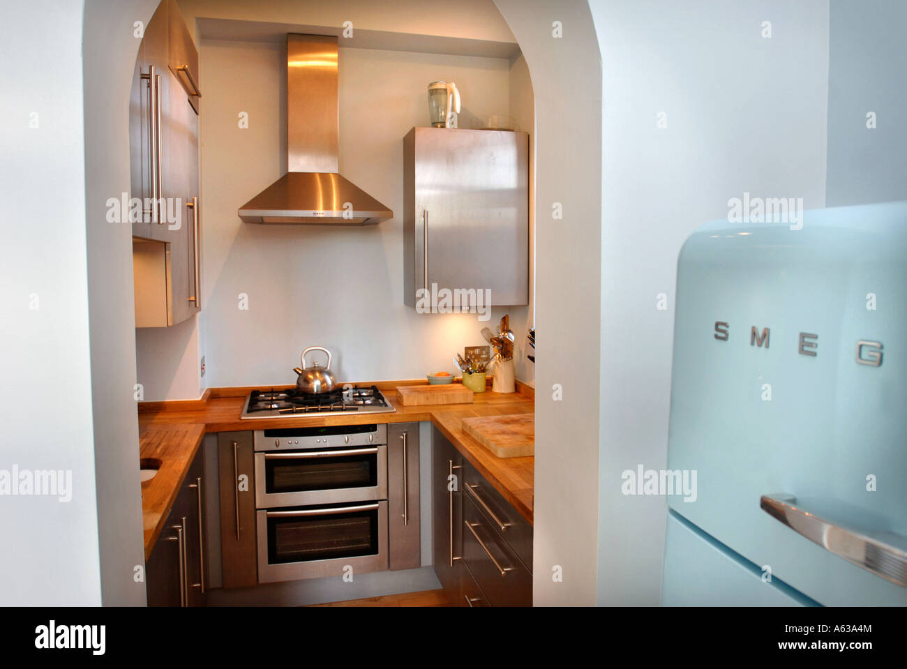A SMALL FITTED KITCHEN WITH A SMEG FRIDGE UK Stock Photo, Royalty Free