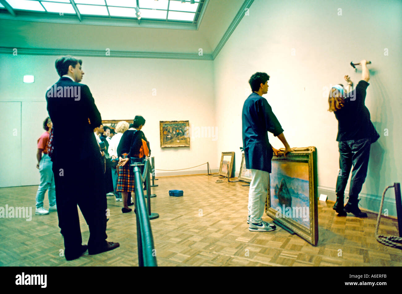 Chicago Illinois USA People Watching Art Curator Hanging FRENCH Impressionist Painting In Chicago Illinois USA People Watching Art Curator Hanging FRENCH Impressionist Painting In