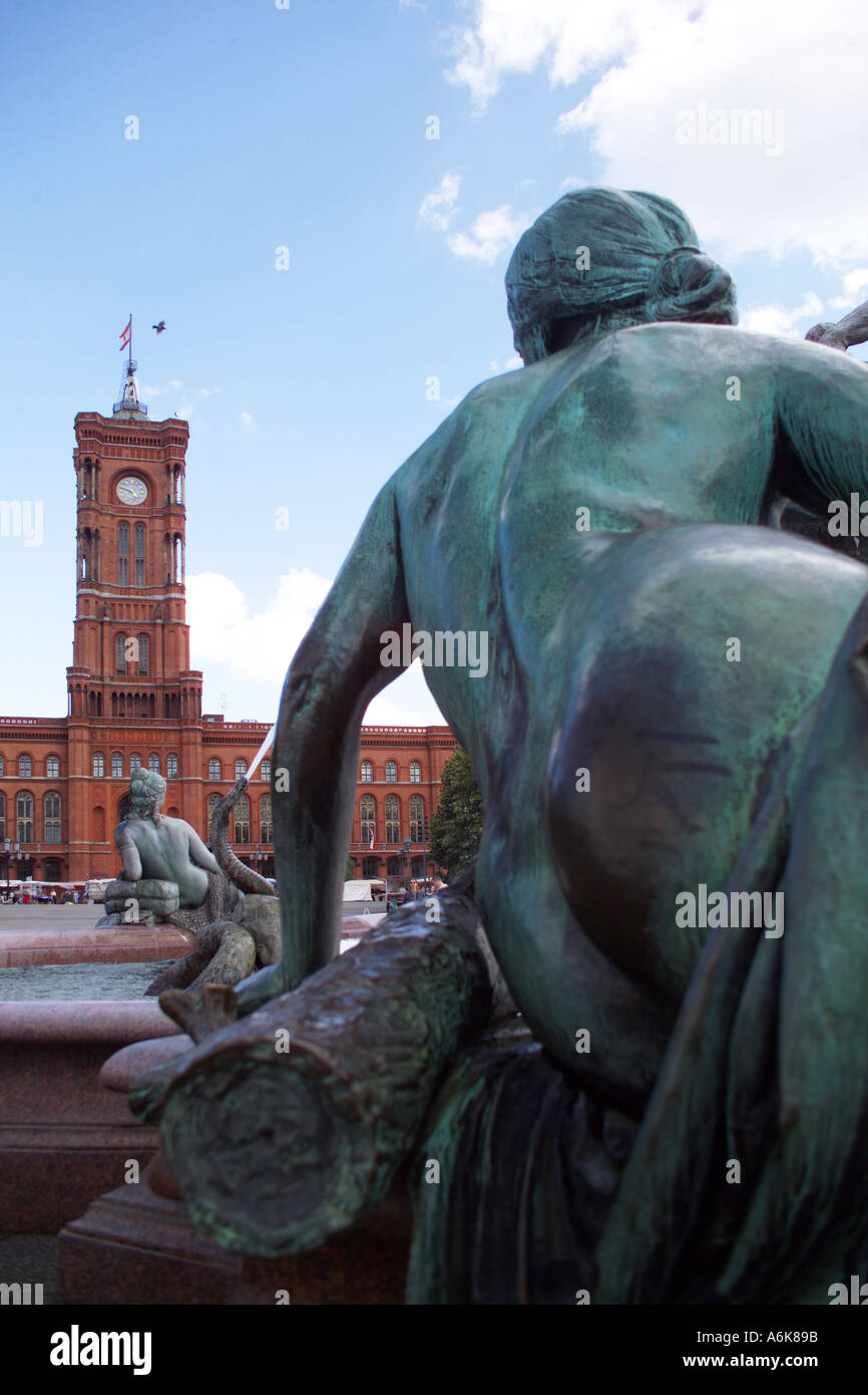 Stock photo sculpture of the neptun fountain in the middle district of berlin germany red house in the background