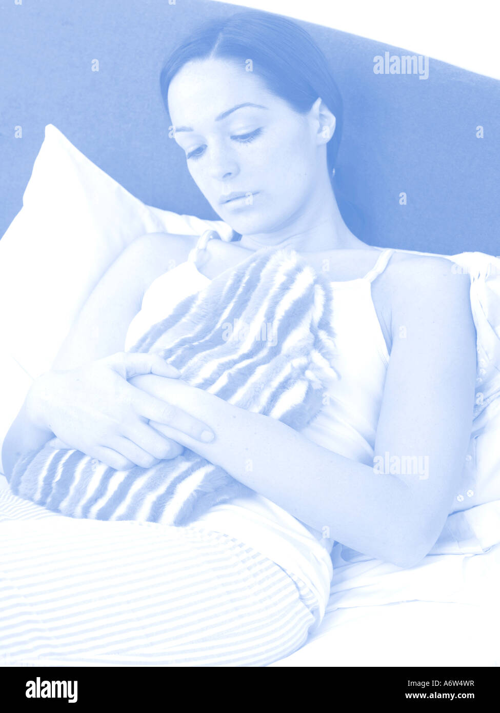 Young Woman Holding Hot Water Bottle Model Released Stock Photo