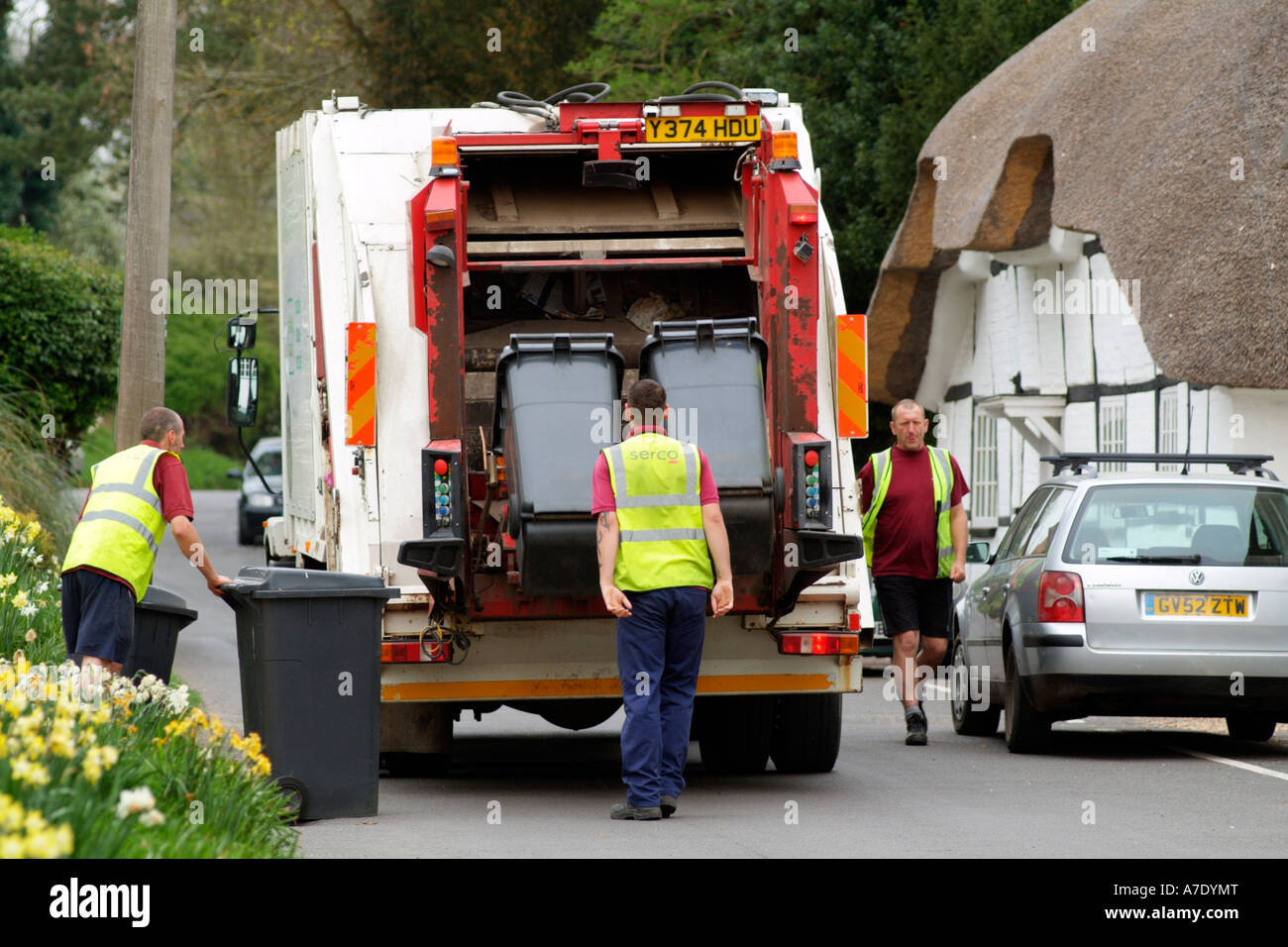 Refuse Operative Dustman Emptying Wheelie Bins Onto A Lorry In A Stock