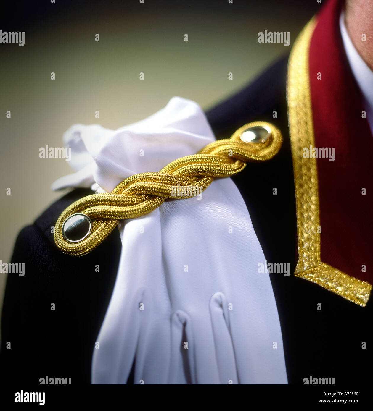 http://c8.alamy.com/comp/A7F66F/hotel-doorman-with-white-gloves-tucked-under-epaulette-london-uk-A7F66F.jpg
