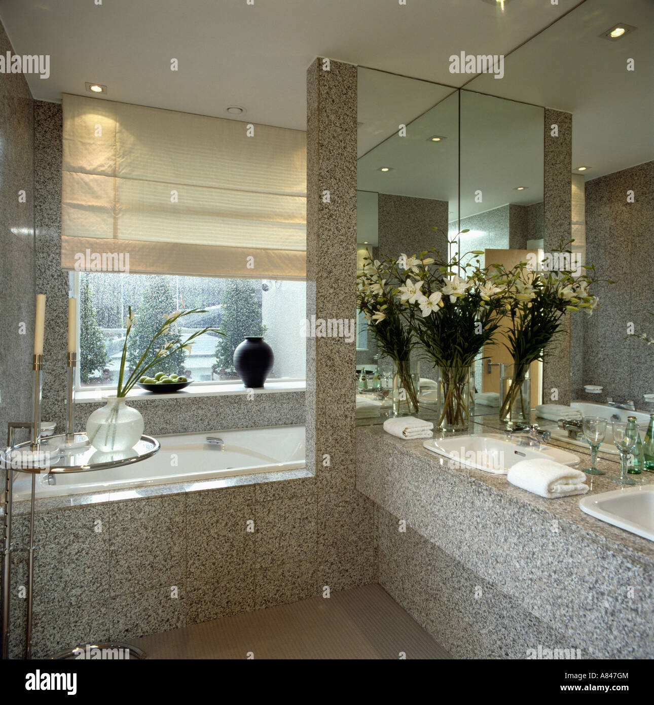 Cream blind at window above bath in grey granite bathroom with Cream blind at window above bath in grey granite bathroom with