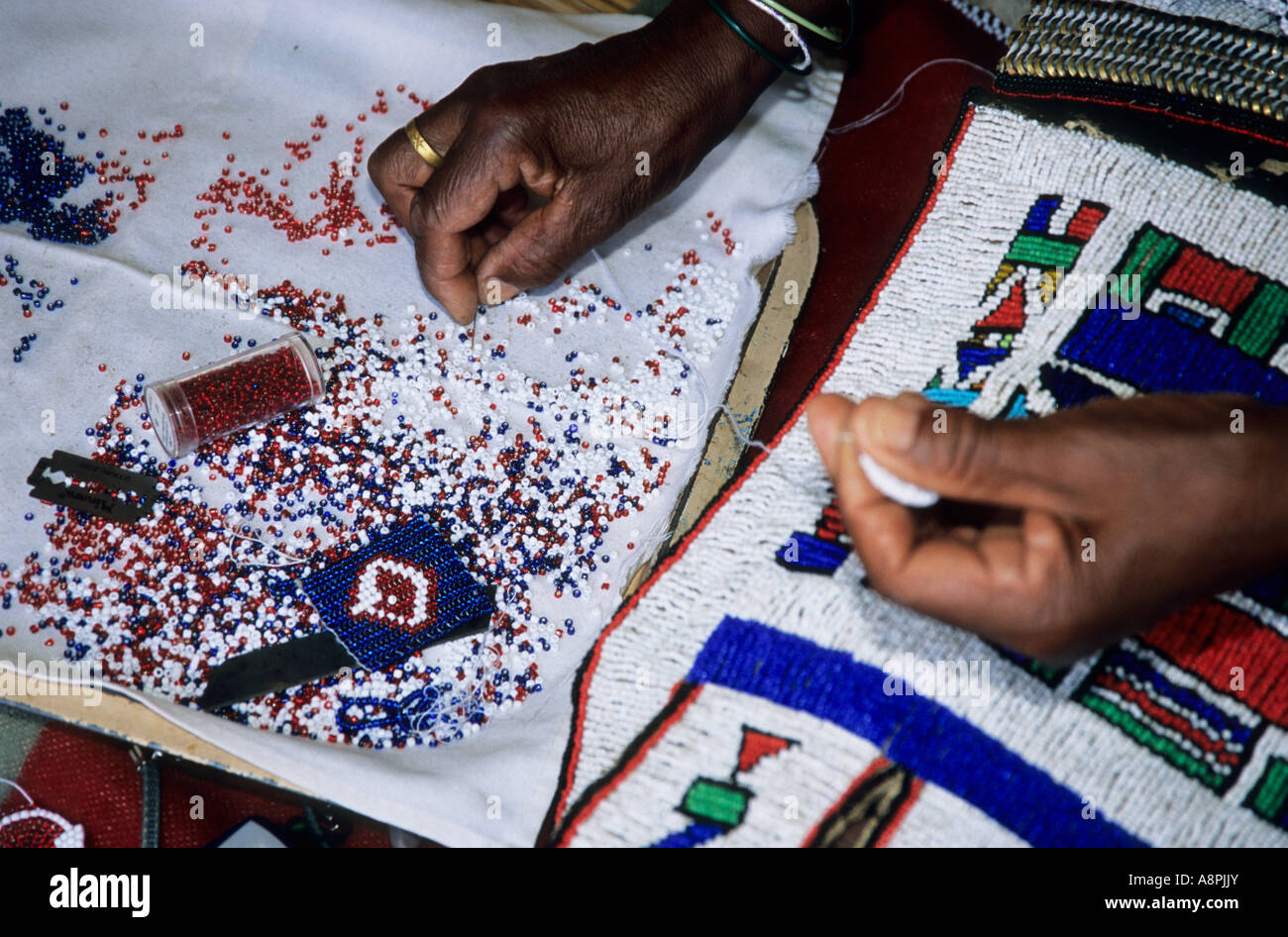Closeup of Ndebele woman hands making traditional African beadwork