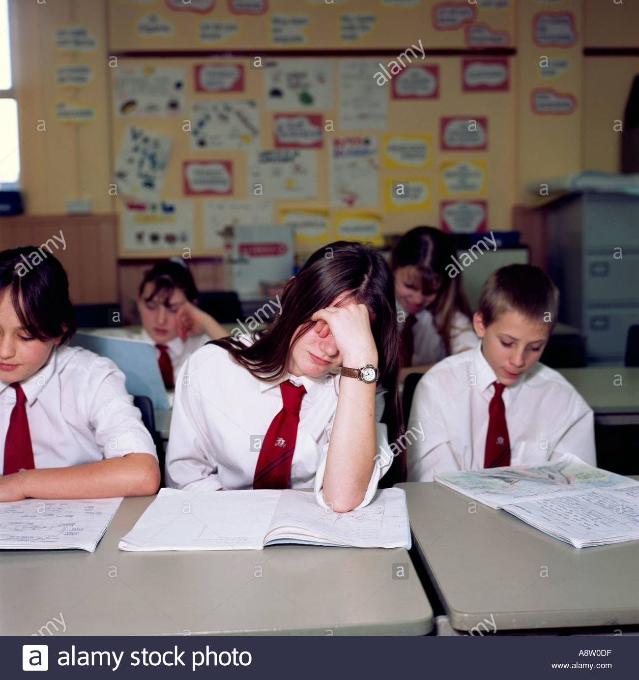 Schoolgirl looking bored lethargic in class at secondary school Isle Stock Photo, Royalty Free