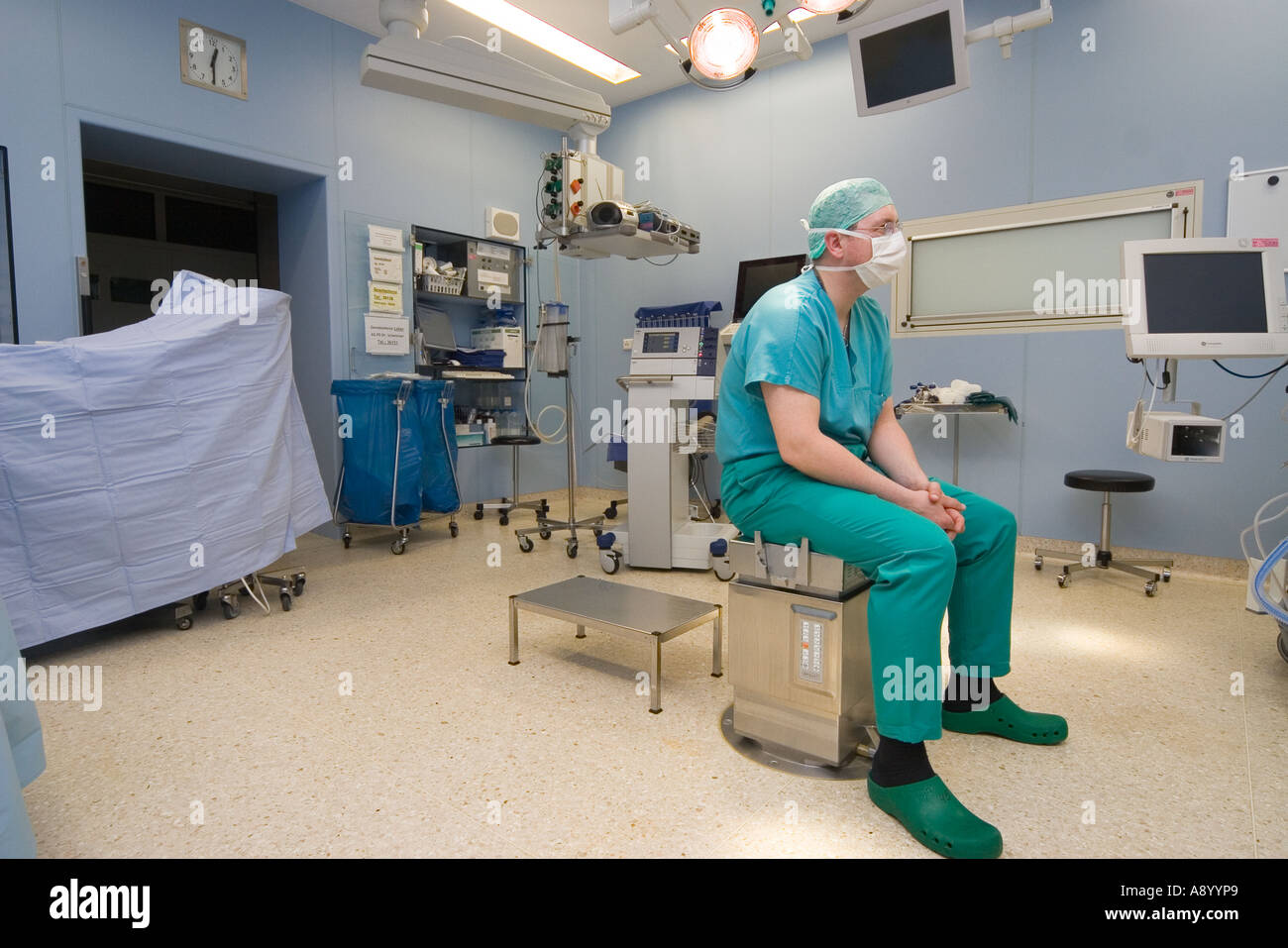 exhausted surgeon waiting at night for next surgery patient Stock Photo
