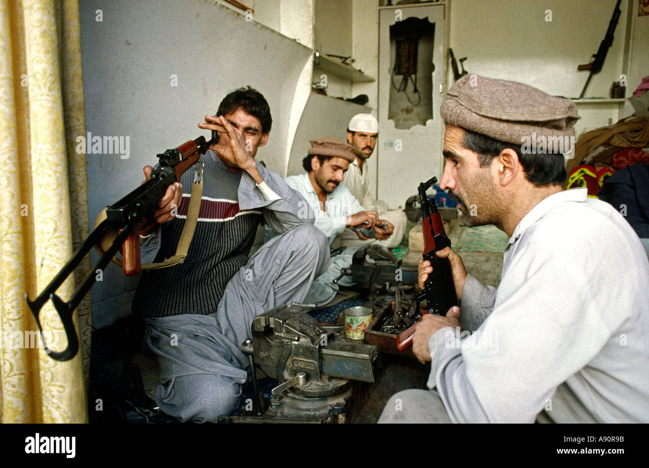 Pakistan NWFP Darra Adam Khel maker inspecting AK47 Kalashnikov gun