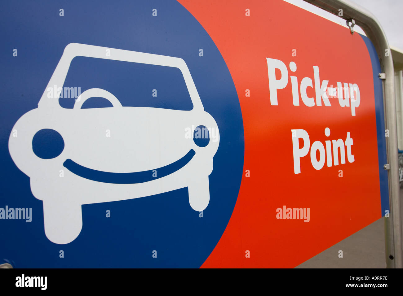 Pick Up Point Sign With Blue Car Logo Lettering In Red And White Stock pick-up-point-sign-with-blue-car-logo-lettering-in-red-and-white-stock