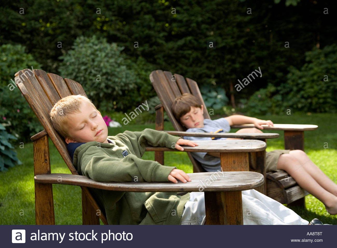 Young Boys Relaxing In Backyard Lawn Chairs Stock Photo Royalty