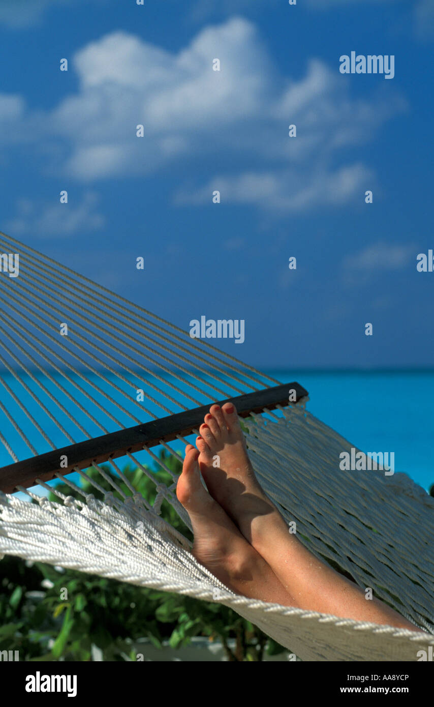 woman-s-feet-in-a-hammock-bahamas-AA8YCP