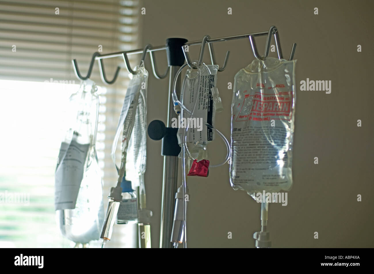 rack of IV intravenous bags hanging in hospital intensive care ward