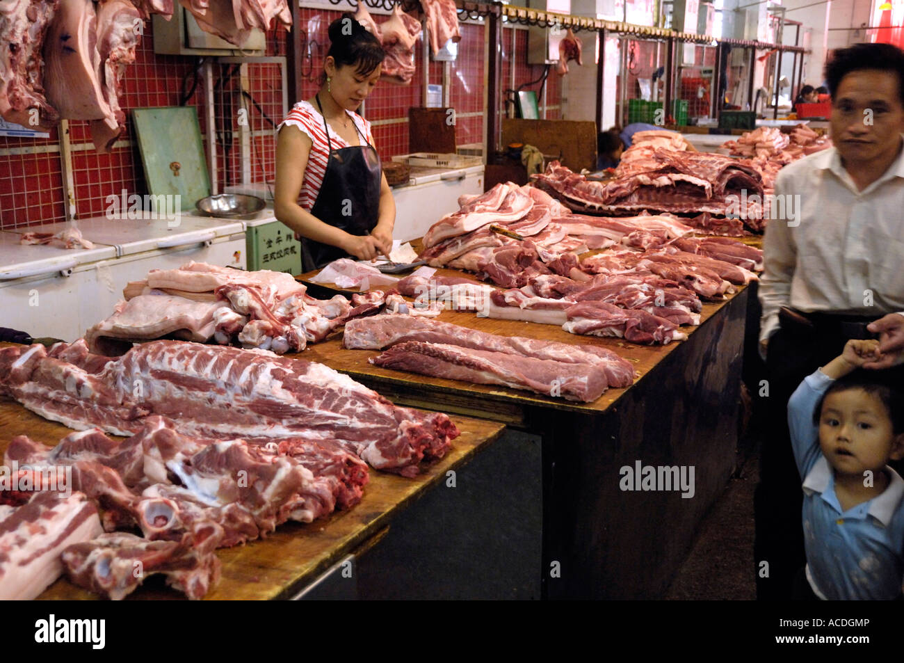 A pork vendor sells fresh pork in a meat market in Beijing, China Stock