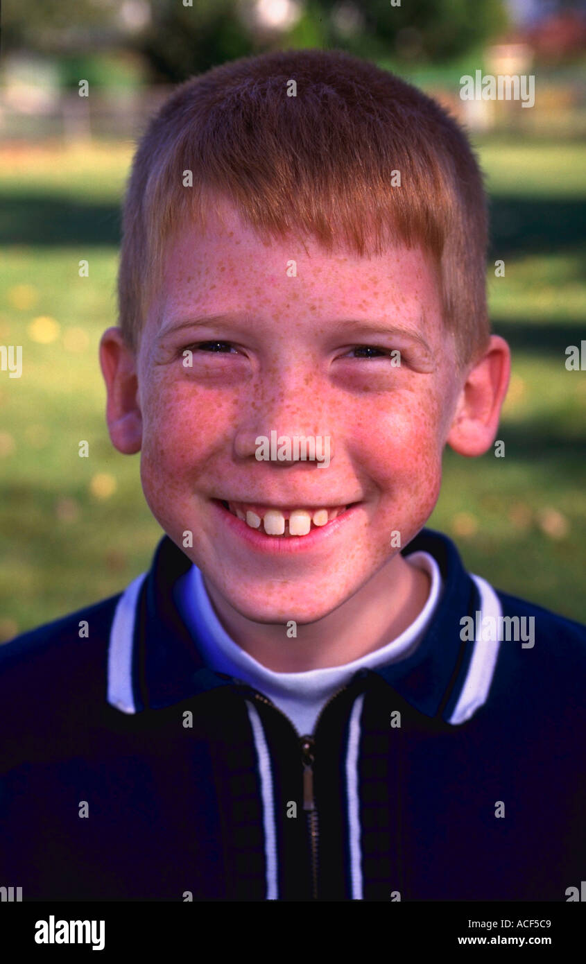 Portrait Of 10 Year Old Redhead Boy With Freckles Smiling Stock Photo