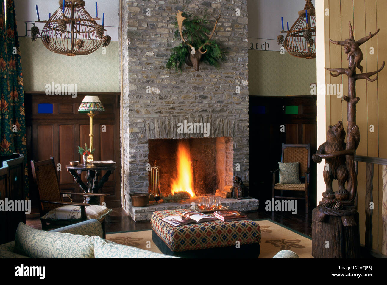 Living room fire in chimney hall stand statue of a bear couches ...