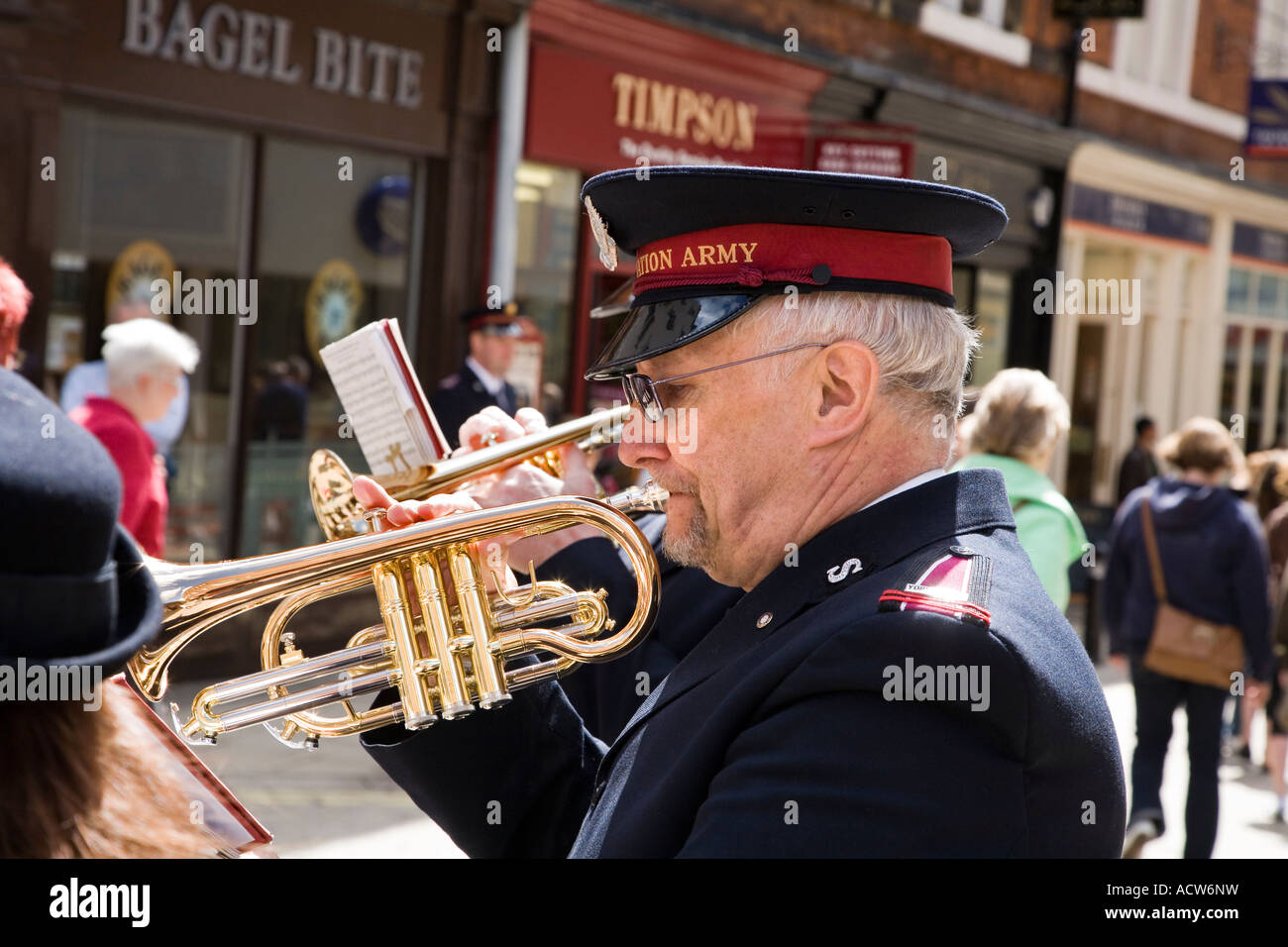 SALVATION ARMY BAND MEMBERS STANDING IN A CIRCLE AND PLAYING IN THE