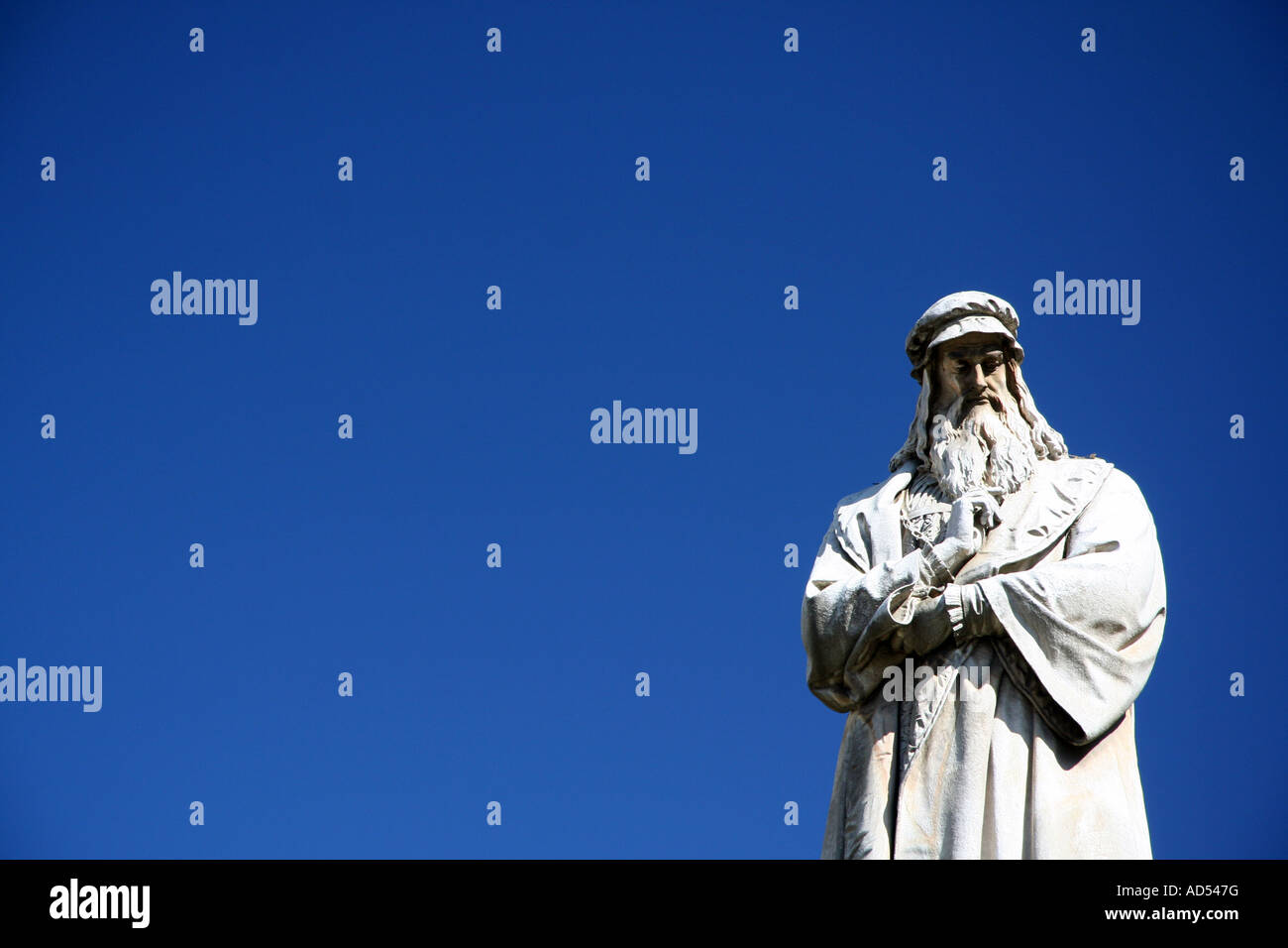 Statue Sculpture Of Leonardo Da Vinci With Clear Blue Sky Milano Stock