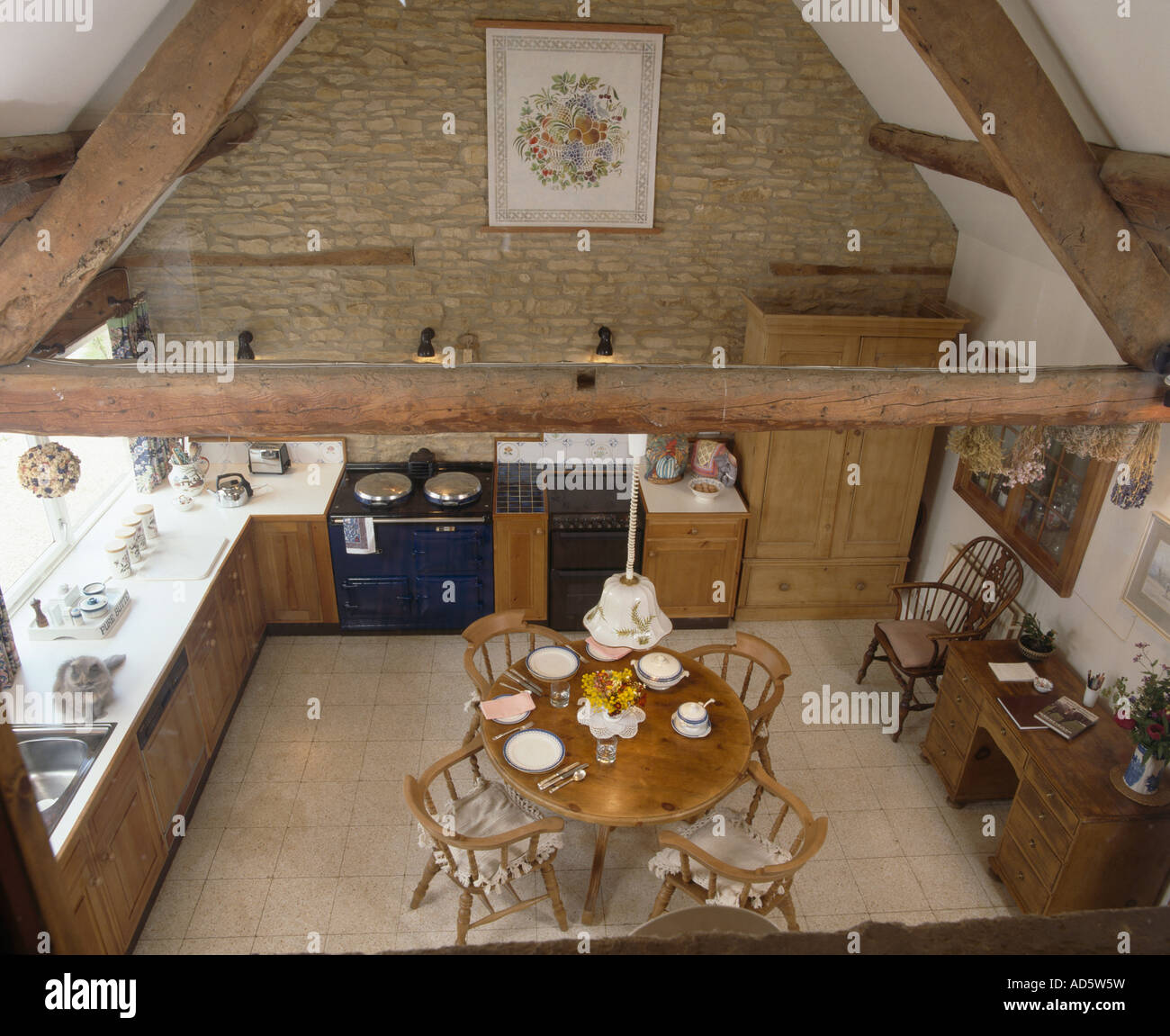 Barn Conversion Kitchens aerial view of circular wooden dining table and chairs in barn Barn Conversion Kitchens aerial view of circular wooden dining table and chairs in barn