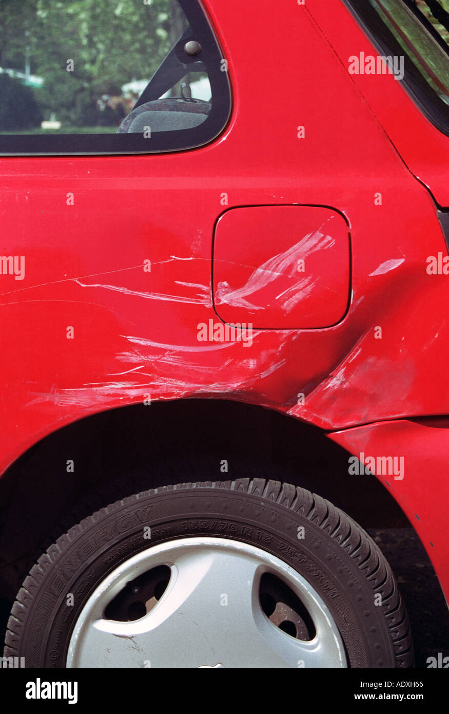 crash damage scratch and dent on red car Stock Photo, Royalty Free