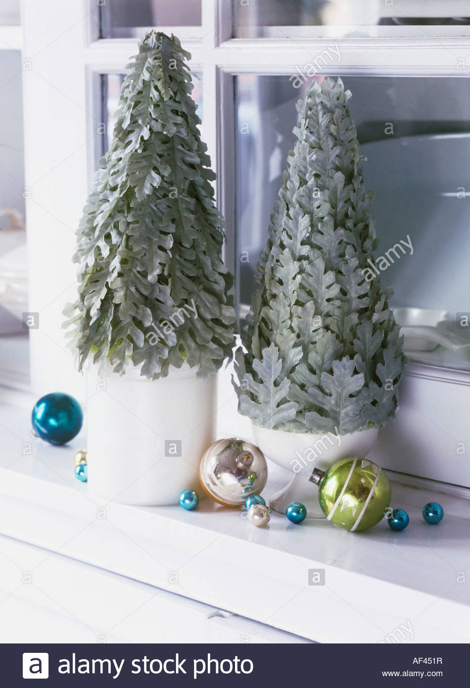 small christmas trees with baubles on a window sill stock small christmas trees with baubles on a window sill stock