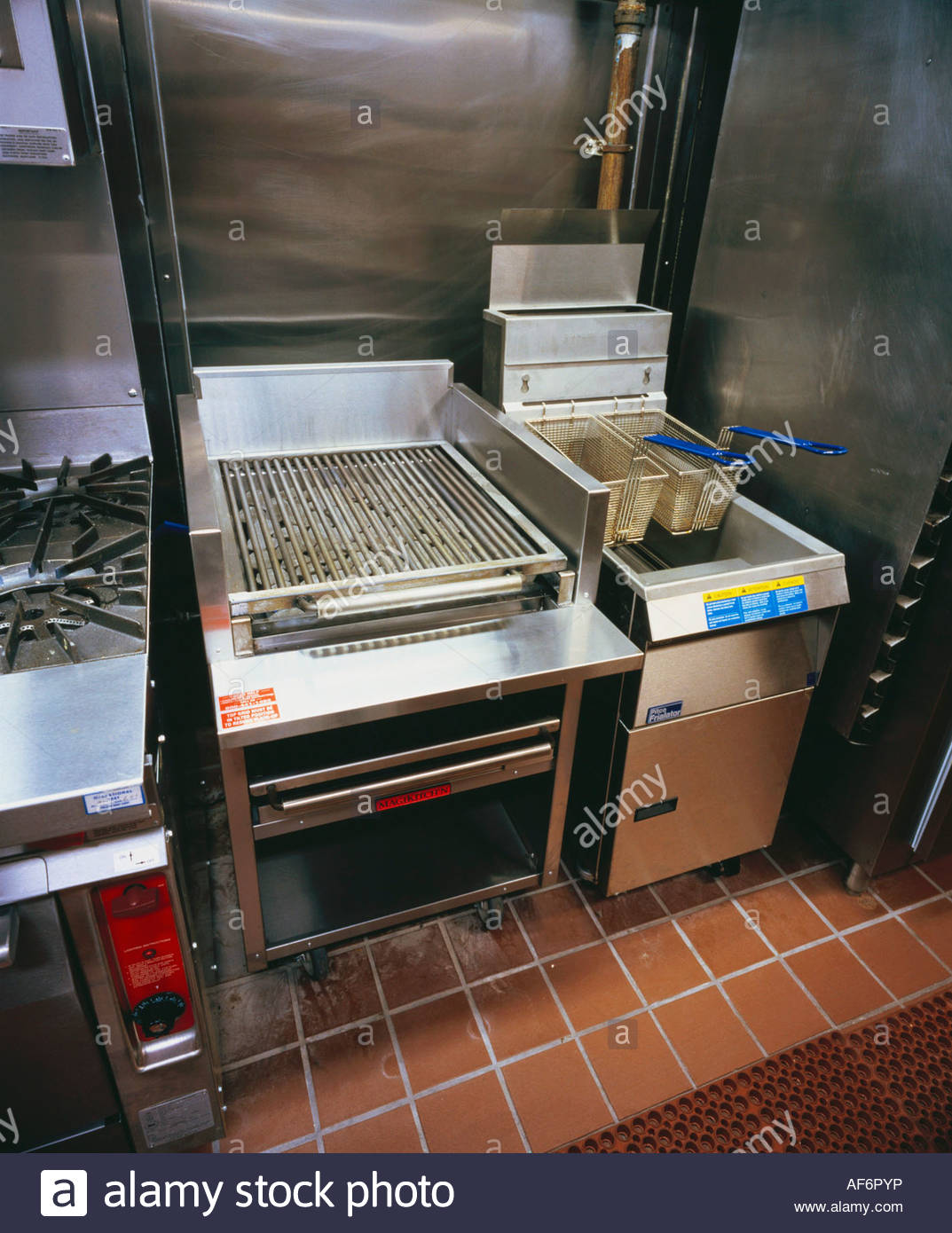 Restaurant Kitchen Grill grill and deep fryer in a restaurant kitchen stock photo, royalty Restaurant Kitchen Grill grill and deep fryer in a restaurant kitchen stock photo, royalty