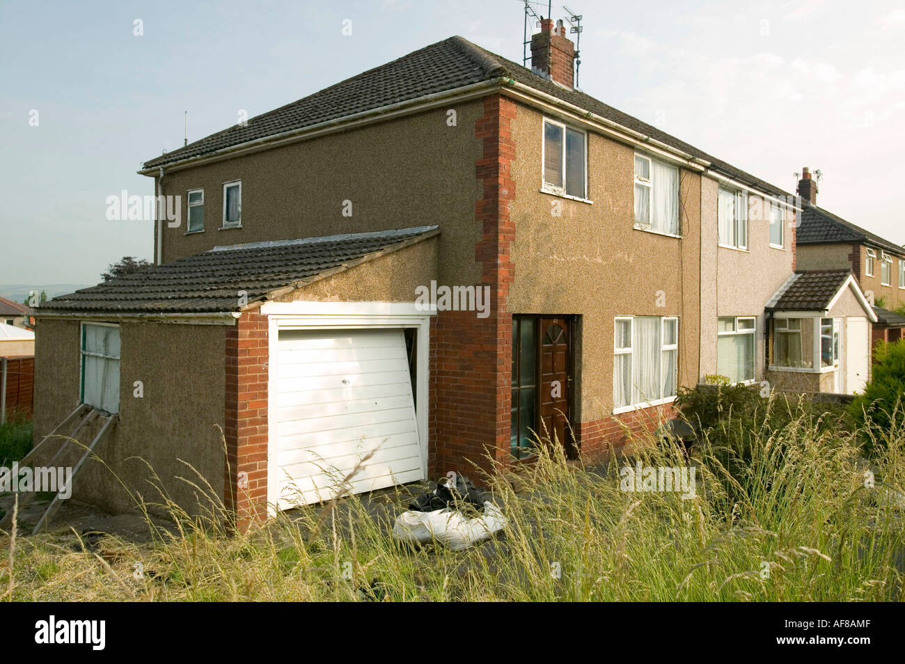 Semi Detached House a run down , neglected semi detached house next to a well loooked Semi Detached House a run down , neglected semi detached house next to a well loooked