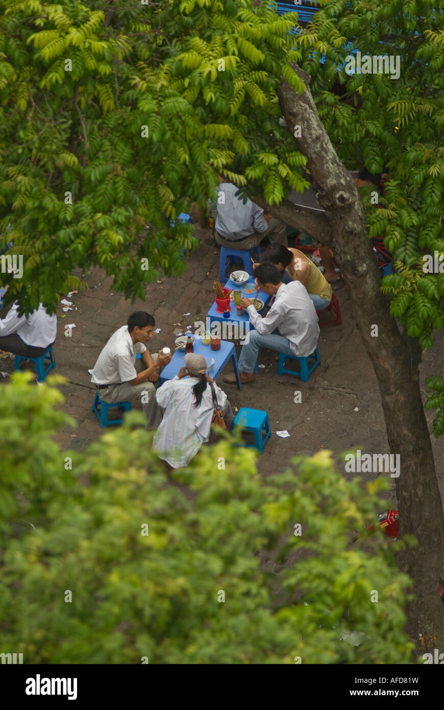 A Group Of Workers Eating Breakfast At A Street Stall Hanoi Vietnam