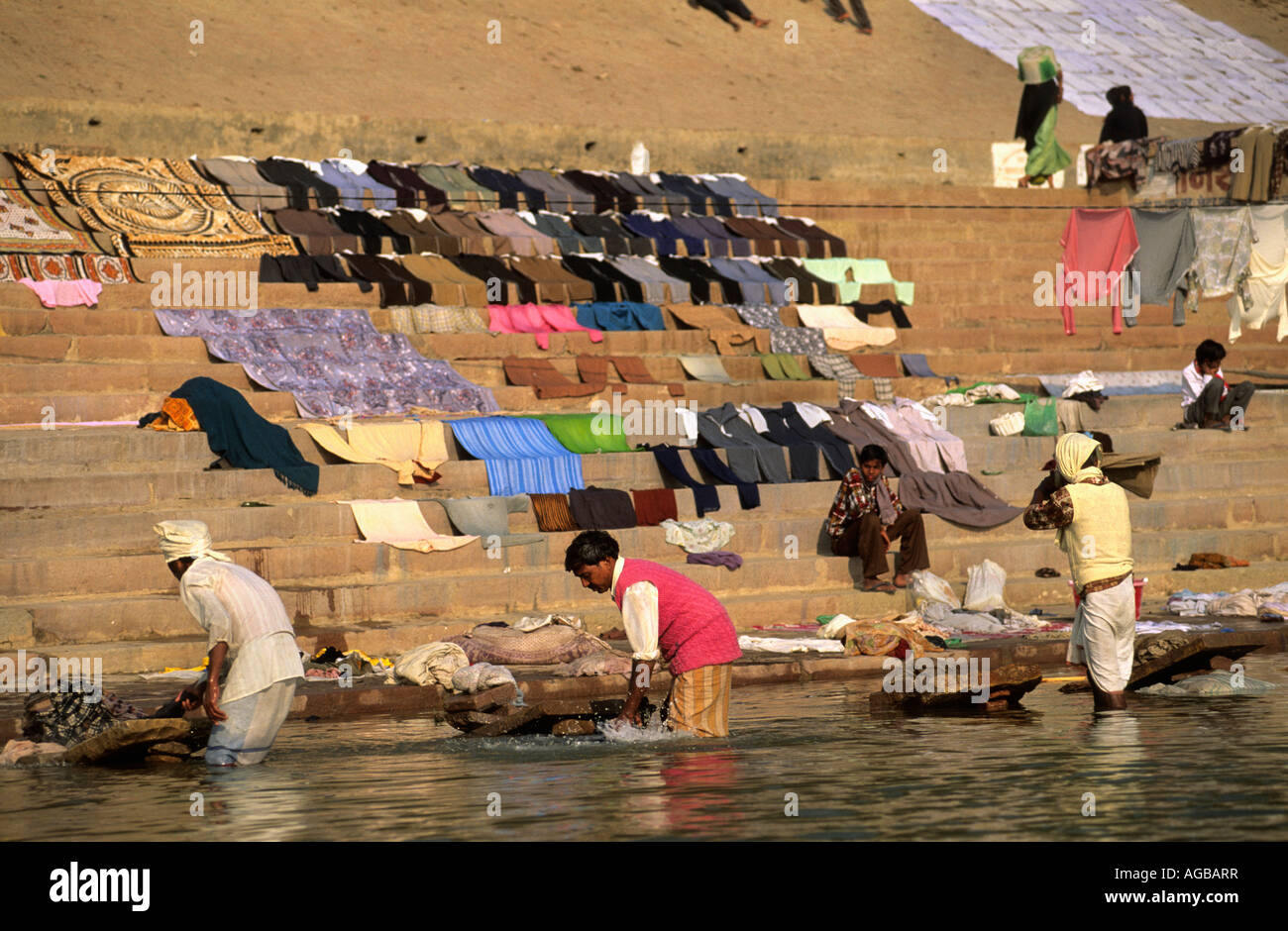 India, Varanasi, People washing clothes in Ganges River Stock Photo