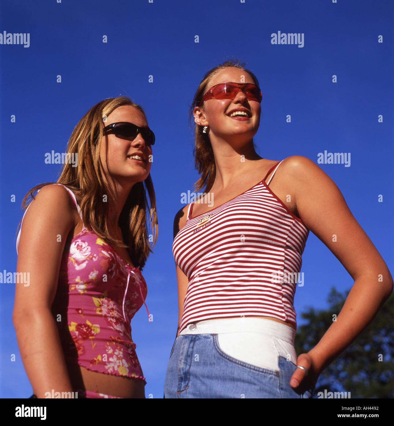 Small Teens two trendy teens teenage girls wearing sunglasses and small tops Small Teens two trendy teens teenage girls wearing sunglasses and small tops