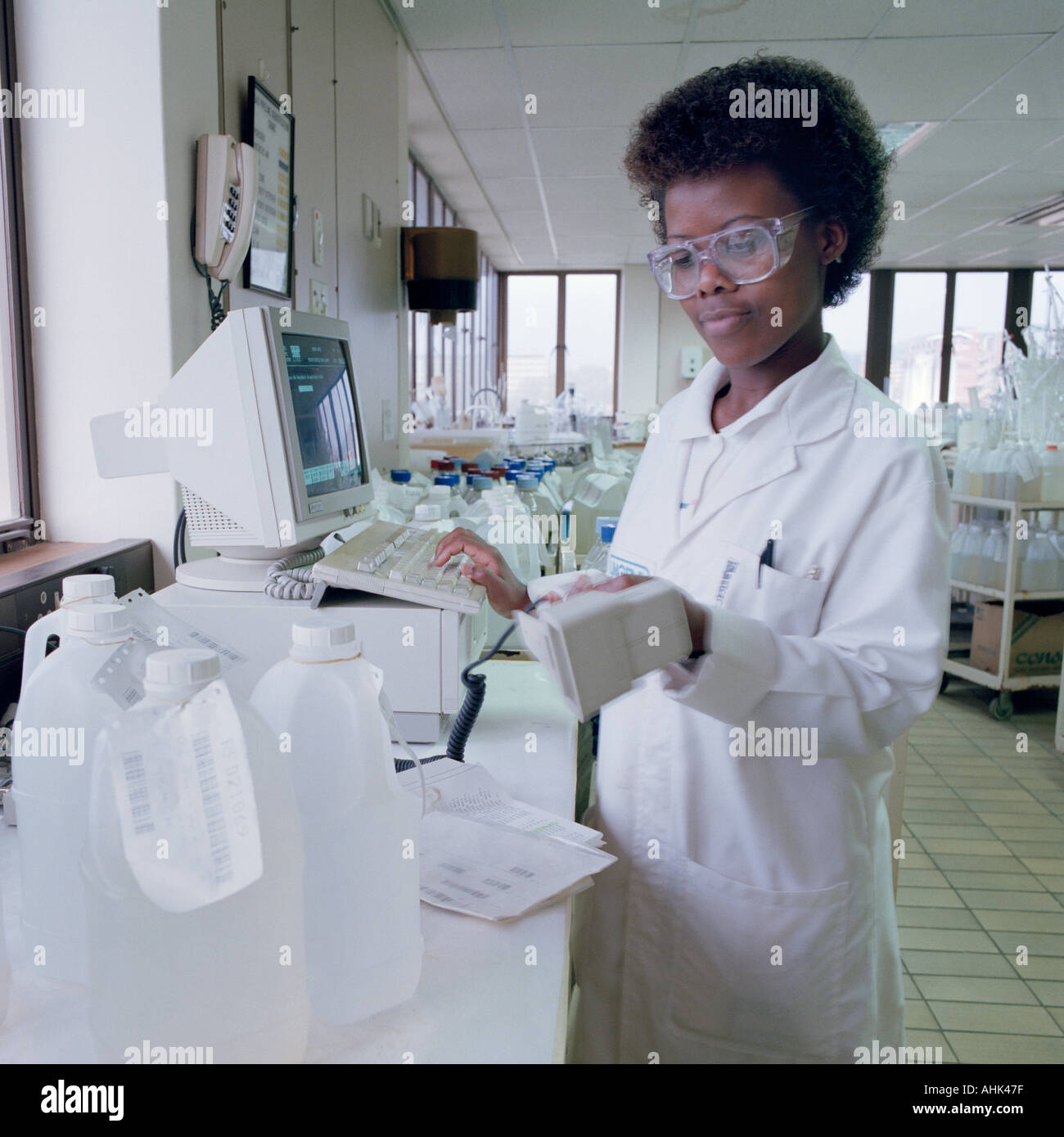 Female laboratory technician monitoring the quality and safety of Stock