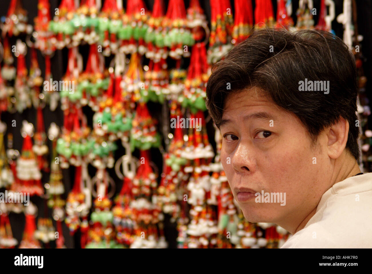 Chinese Man at a Jade Keychain <b>Souvenir Shop</b>, Stanley Market, Hong Kong, <b>...</b> - chinese-man-at-a-jade-keychain-souvenir-shop-stanley-market-hong-kong-AHK7R0