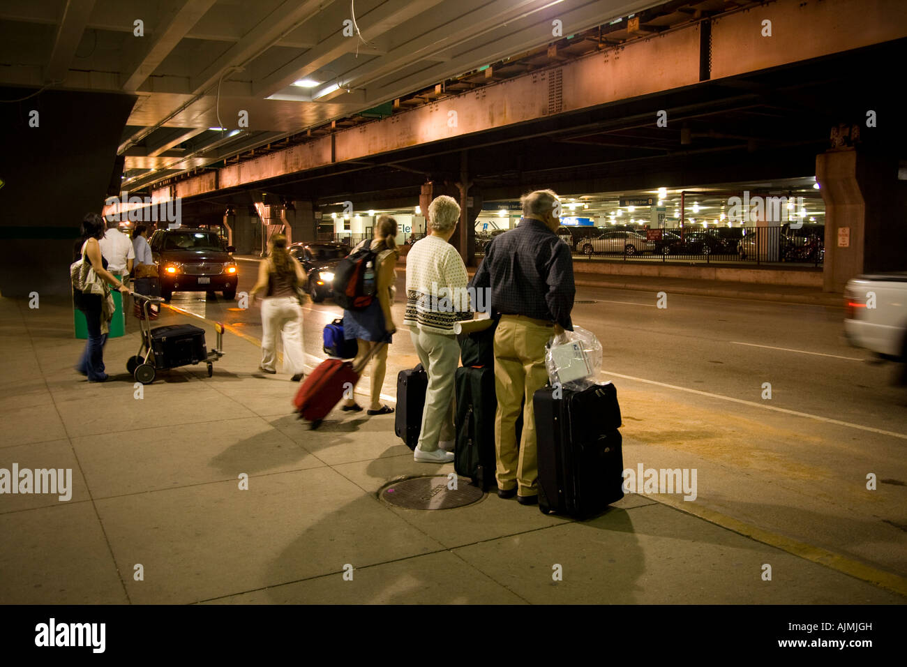 People at airport curbside pickup awaiting rides Chicago O'hare Stock