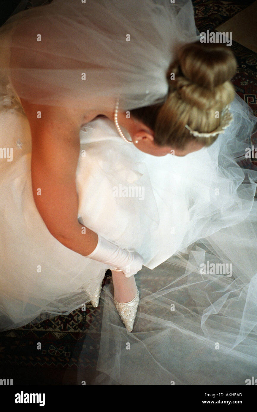 putting on her wedding dress